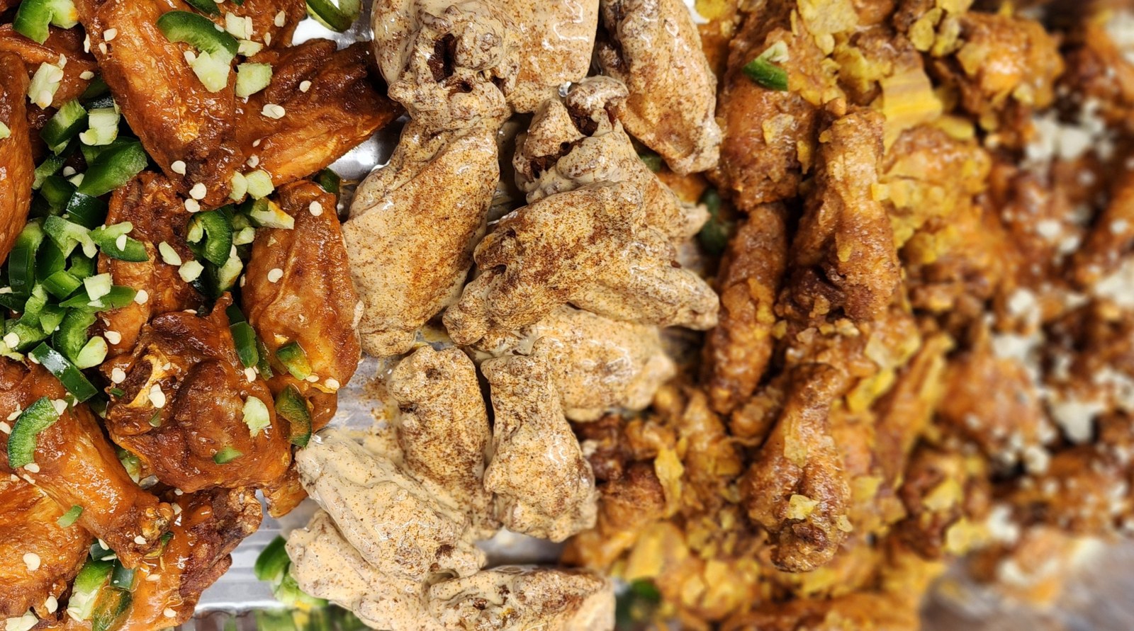 Trays of sauced and dry rubbed chicken wings from Double Dub's MKE wing truck in Milwaukee