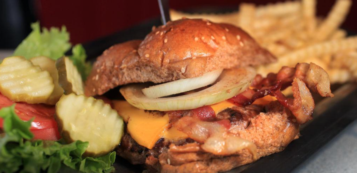 Bacon cheeseburger with melted cheese, bacon, and onion at Badger Tavern in Madison