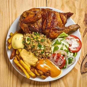 Pollo a la Brasa plate with rice, fries, salad and sauces at Pikkito in west Madison