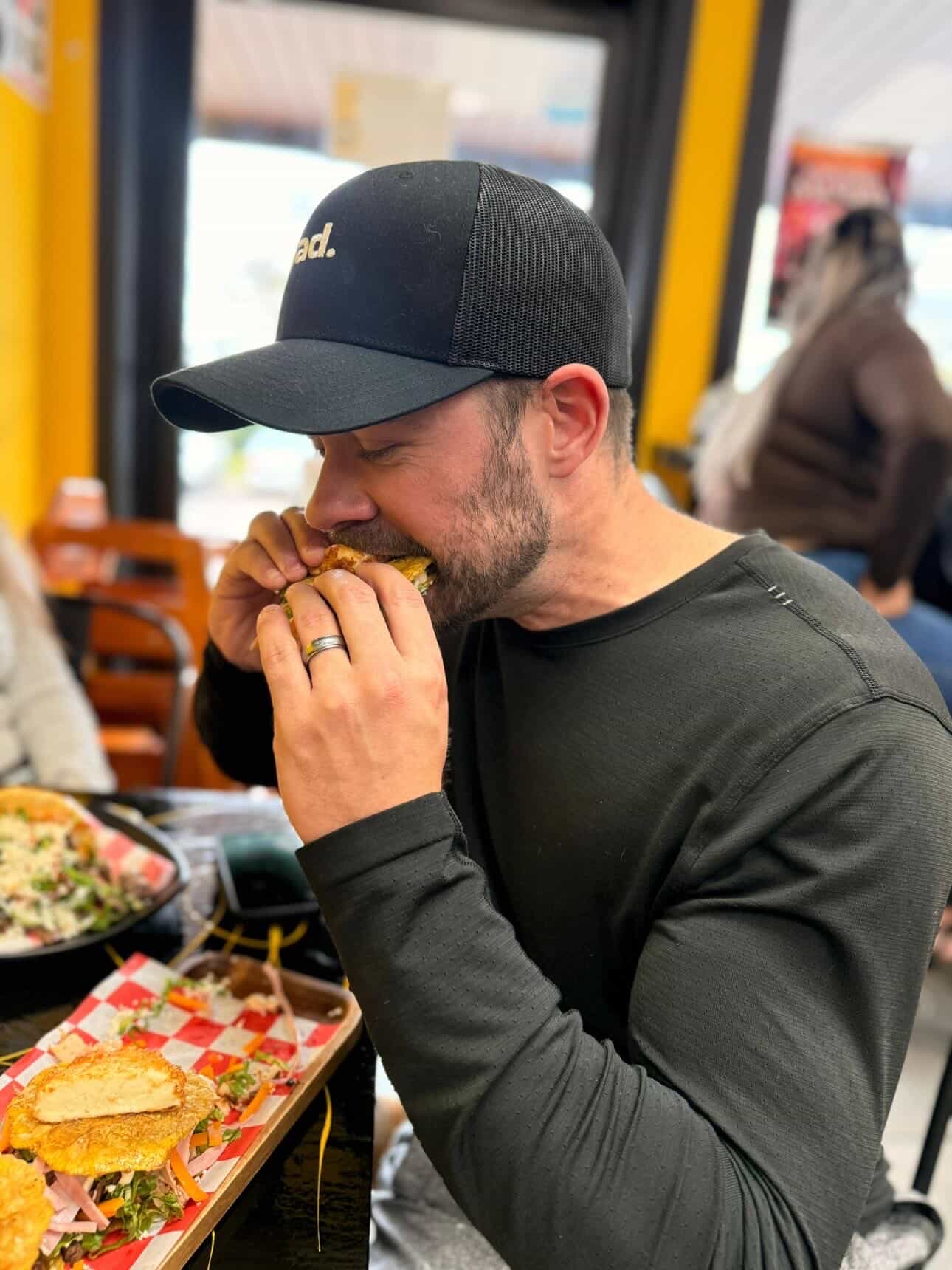Troy Munson eating a sandwich at a local Wisconsin spot