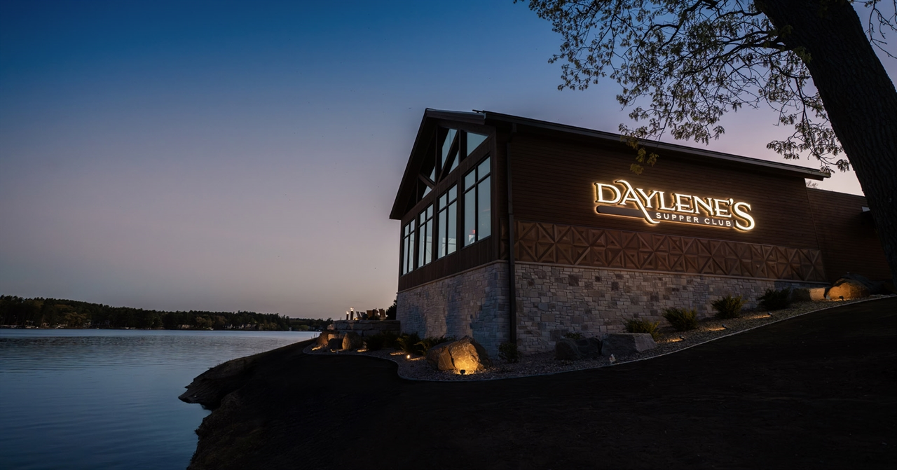 Exterior of Daylene's Supper Club on Lake Delton at dusk with the lit sign